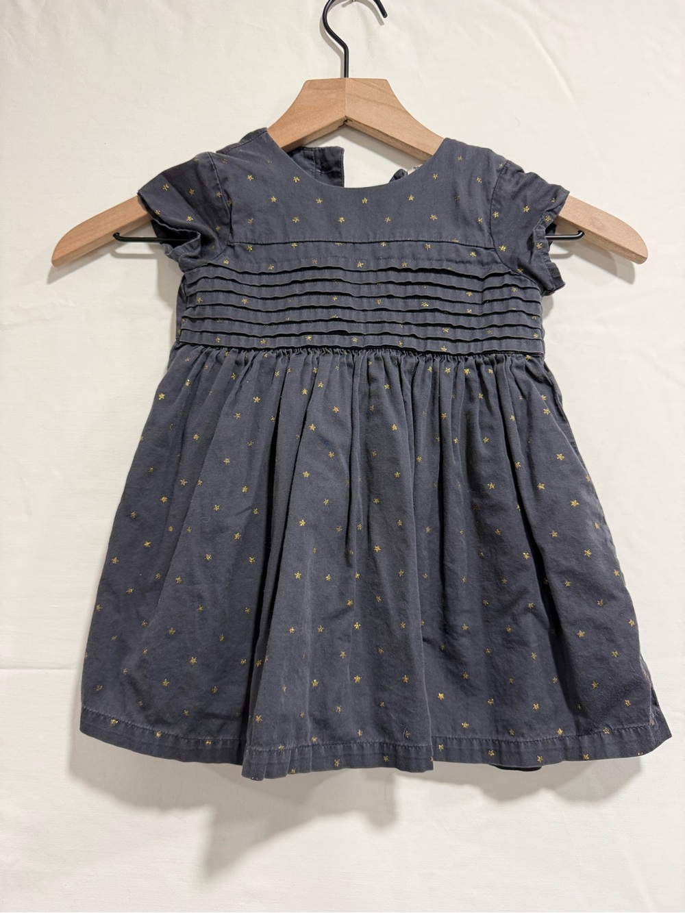 The cropped open-front cardigan has delicate ruffled trim along the hem and cuff